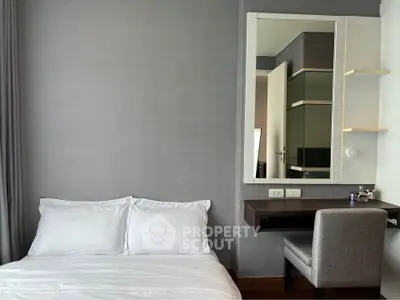 Modern bedroom with sleek design and cozy bed, featuring a stylish vanity area and neutral color palette.