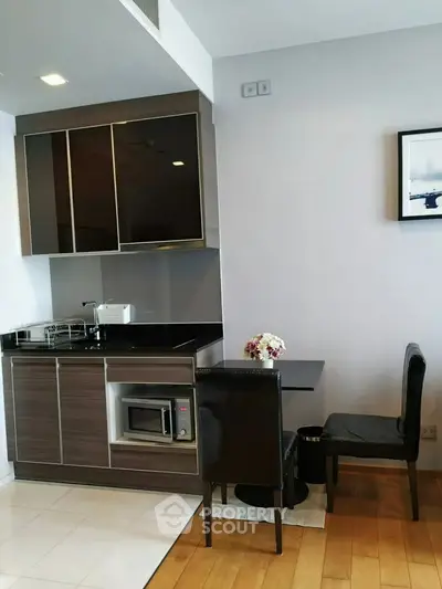 Modern compact kitchen with dining area in stylish apartment