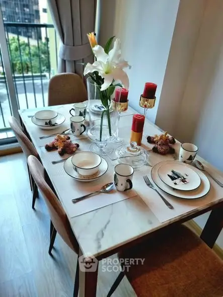 Elegant dining setup with modern decor and city view from balcony