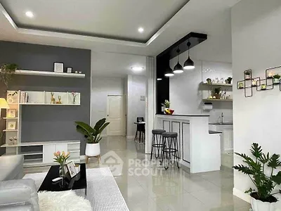 Modern open-plan living room with stylish kitchen and elegant decor.