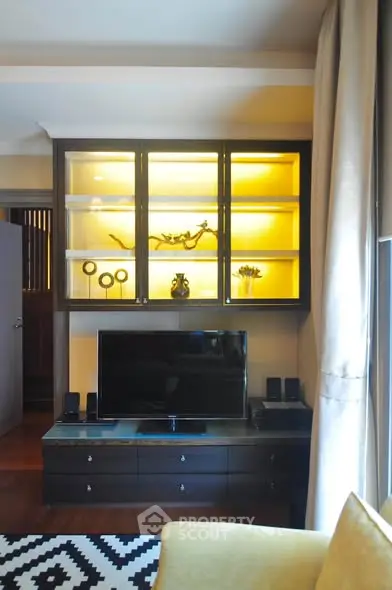Stylish living room with modern TV unit and illuminated display cabinet