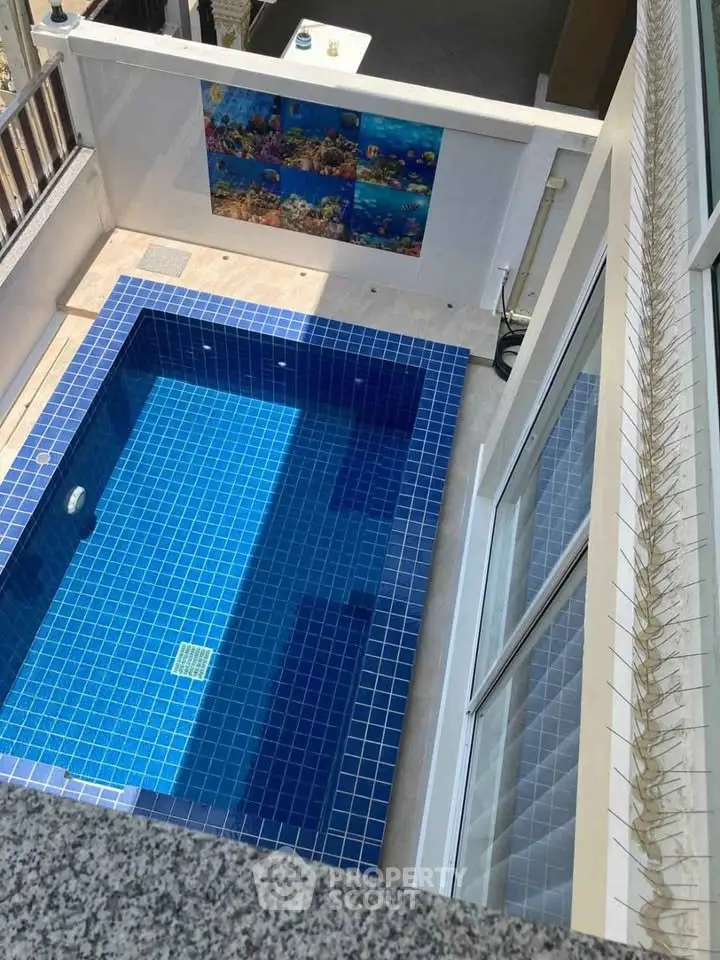 Luxurious private pool with blue tiles in modern residential setting