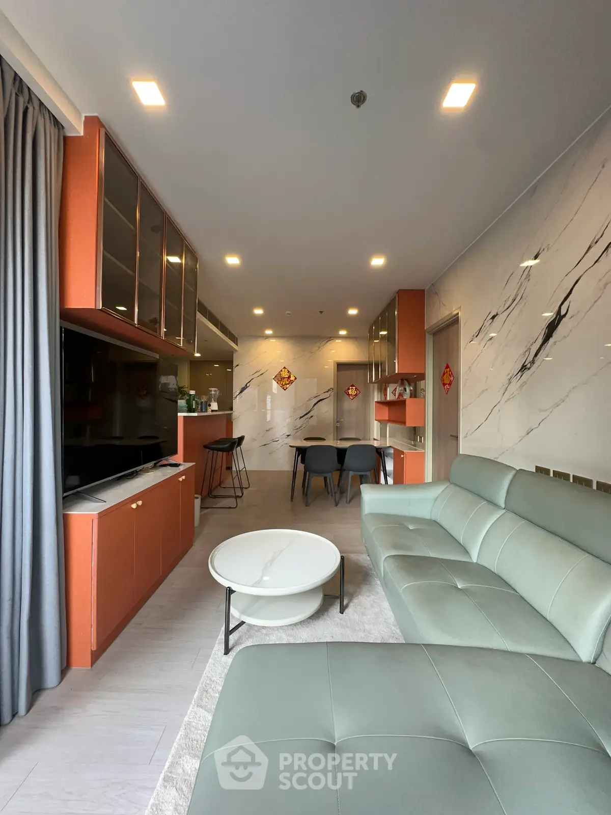 Modern living room with sleek furniture and stylish decor, featuring a spacious layout and elegant finishes.