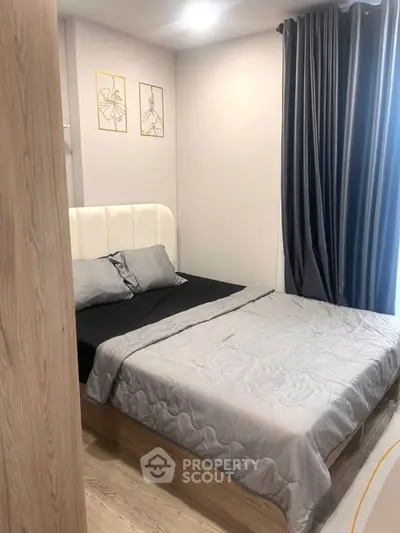 Cozy bedroom with modern decor and soft lighting, perfect for relaxation.
