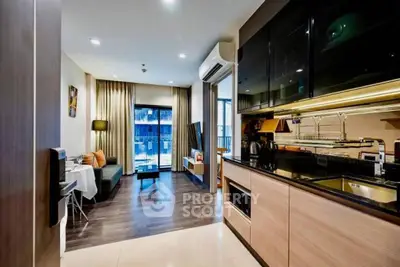 Modern open-layout kitchen and living room with sleek design and natural light.