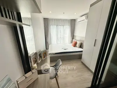 Modern bedroom with stylish decor, large window, and sleek furniture in a contemporary apartment.