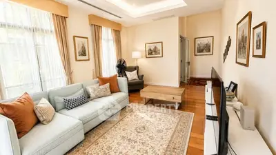 Spacious living room with elegant decor and large windows in a modern apartment.