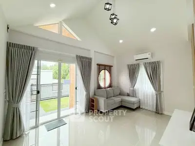 Spacious modern living room with large windows and garden view