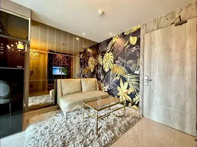 Stylish living room with modern decor and plush rug in a cozy apartment.