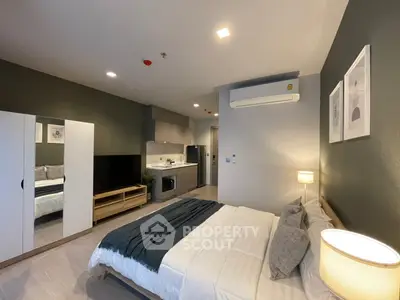 Modern studio apartment with cozy bedroom and compact kitchen
