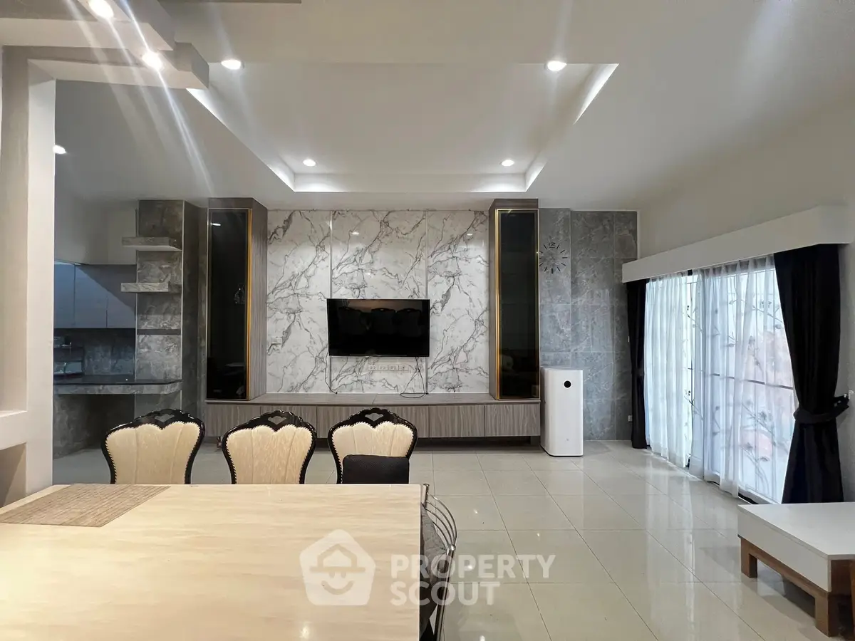Luxurious modern living room with marble accent wall and elegant dining area.