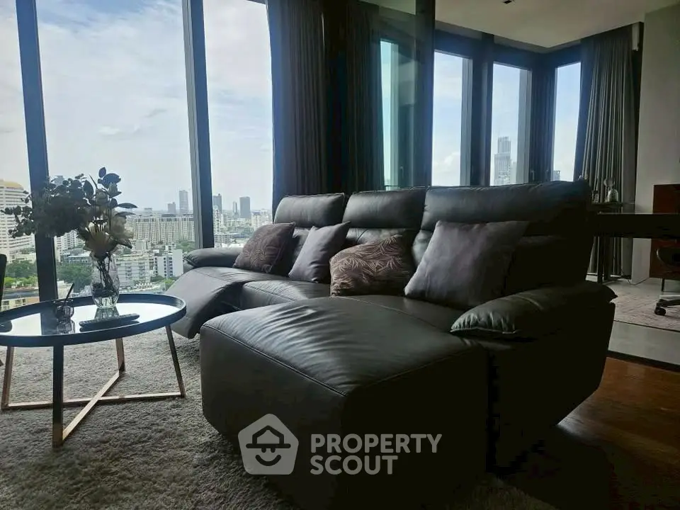 Luxurious living room with panoramic city views and modern leather sofa.