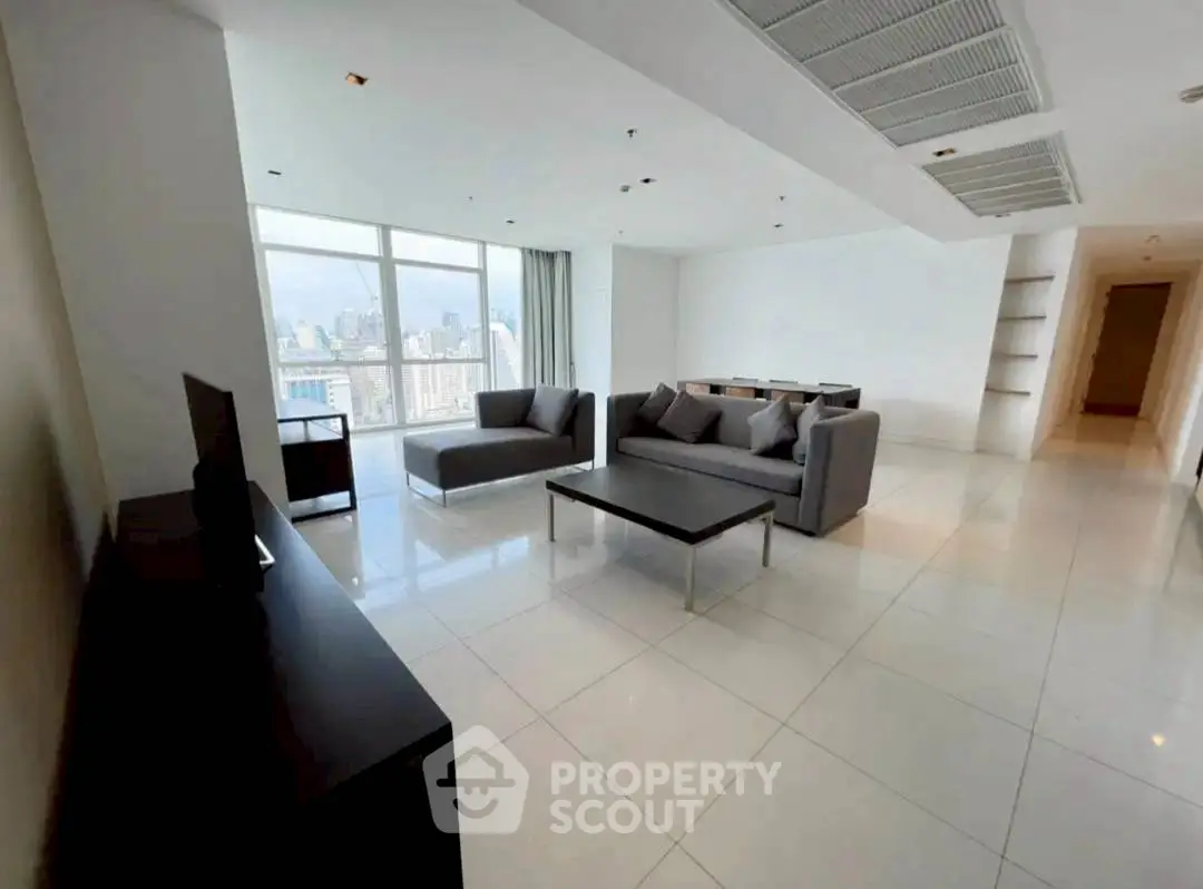 Spacious modern living room with city view and sleek furniture