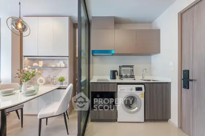 Modern kitchen with washing machine and dining area in stylish apartment