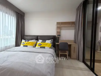 Modern bedroom with study area and large window, perfect for urban living.