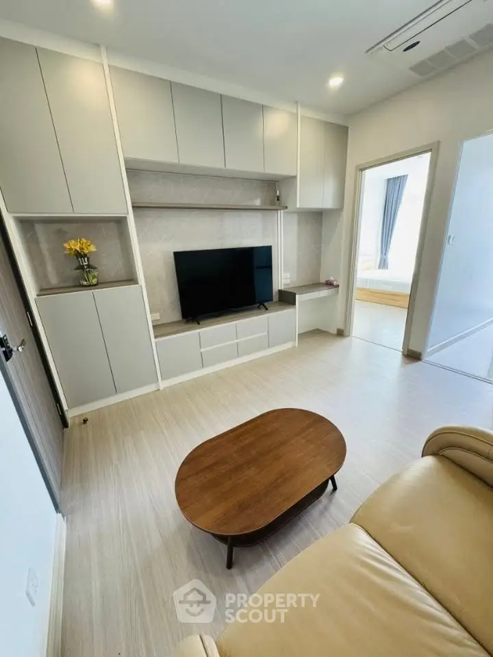 Modern living room with sleek built-in storage and cozy seating, perfect for relaxation and entertainment.