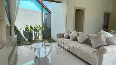 Spacious living room with modern sofa and garden view, perfect for relaxation and entertaining.