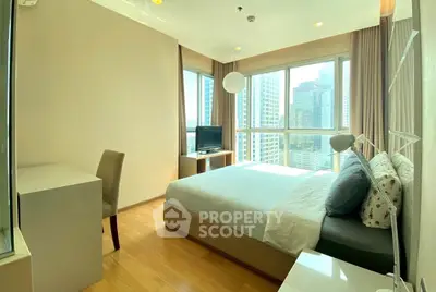 Bright and modern bedroom with city view in high-rise apartment