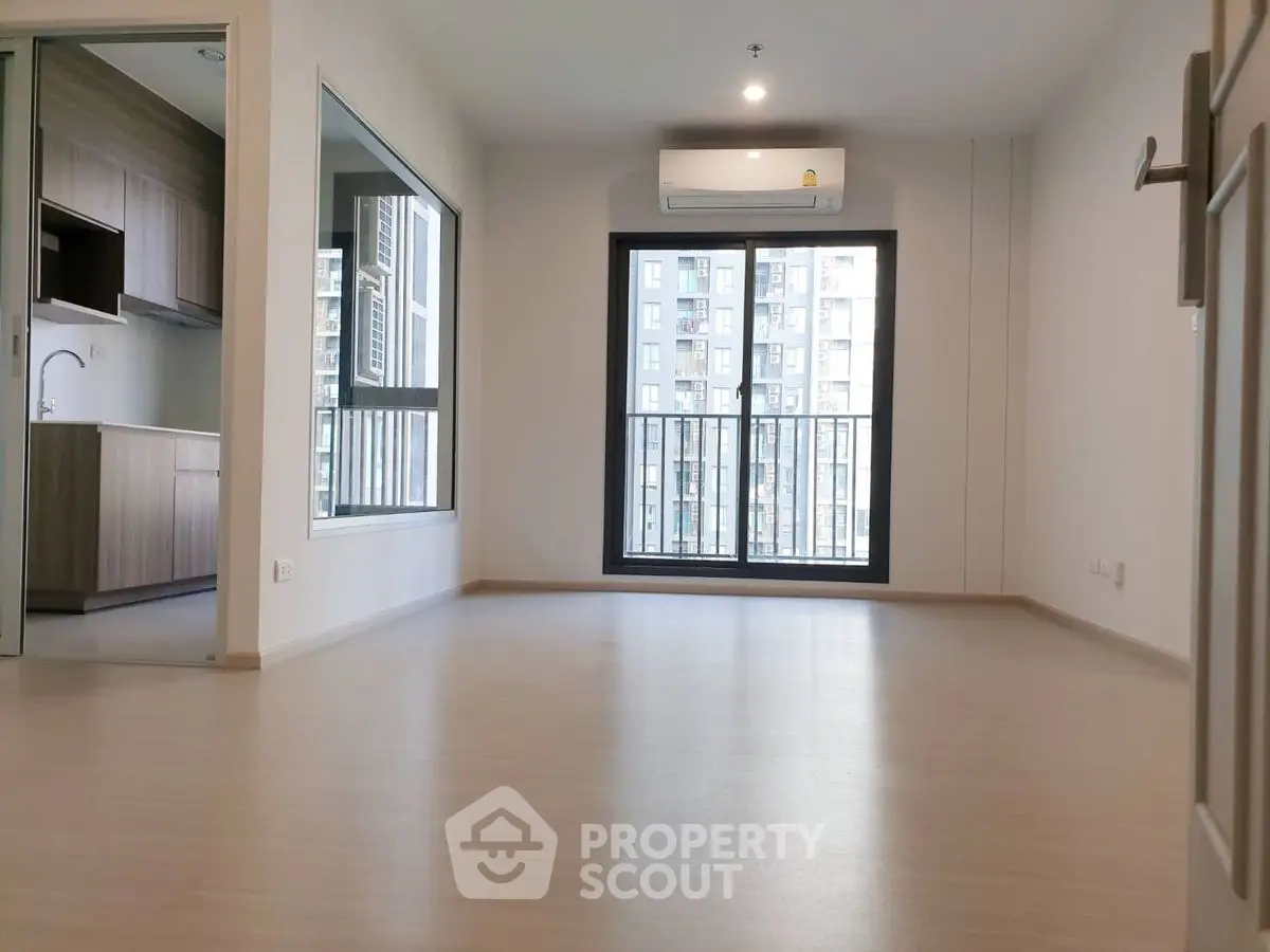 Spacious modern living room with large window and city view