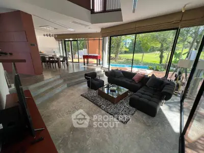 Luxurious modern living room with large windows and garden view