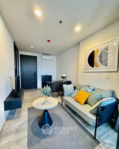 Modern living room with stylish decor and cozy seating in a contemporary apartment.