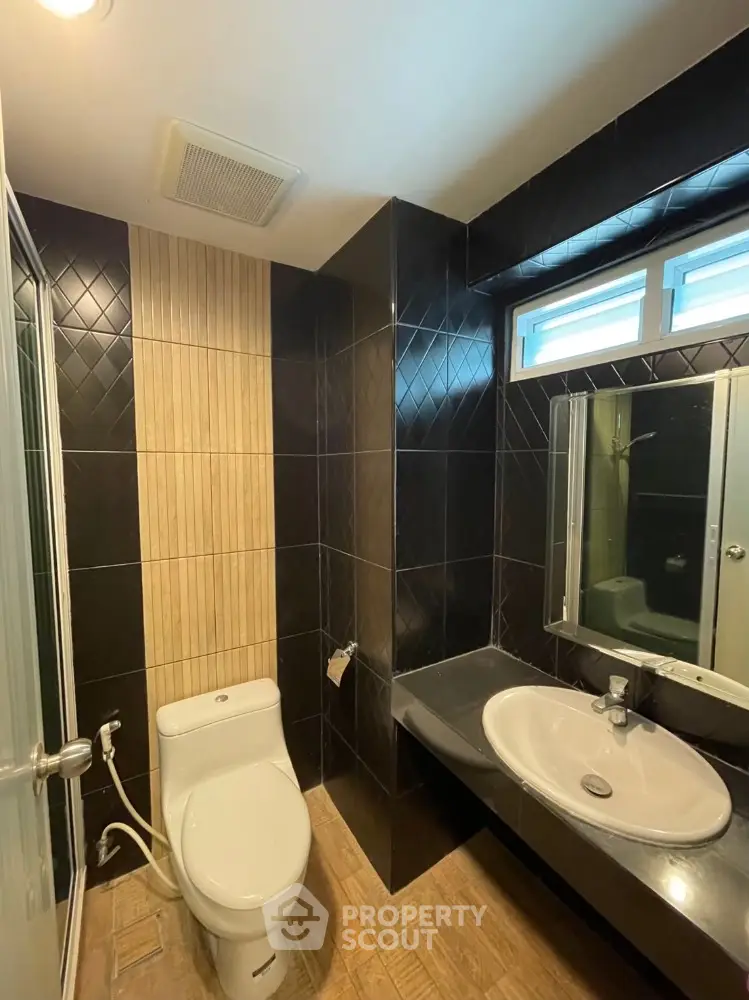 Modern bathroom with sleek black tiles and contemporary fixtures