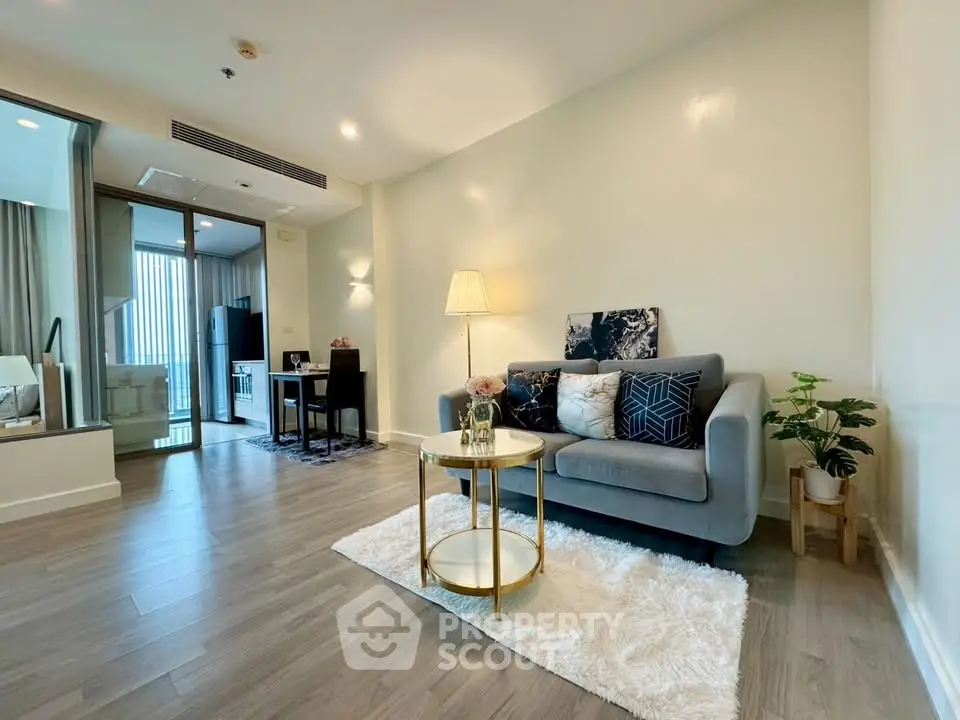 Modern living room with stylish decor and cozy ambiance, featuring a plush sofa and elegant lighting.