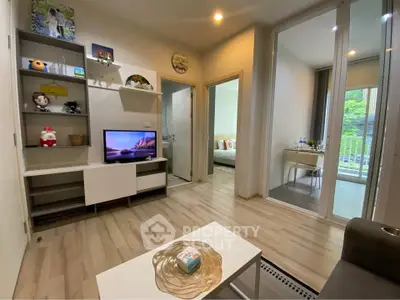 Modern living room with sleek design and open view to bedroom and balcony.