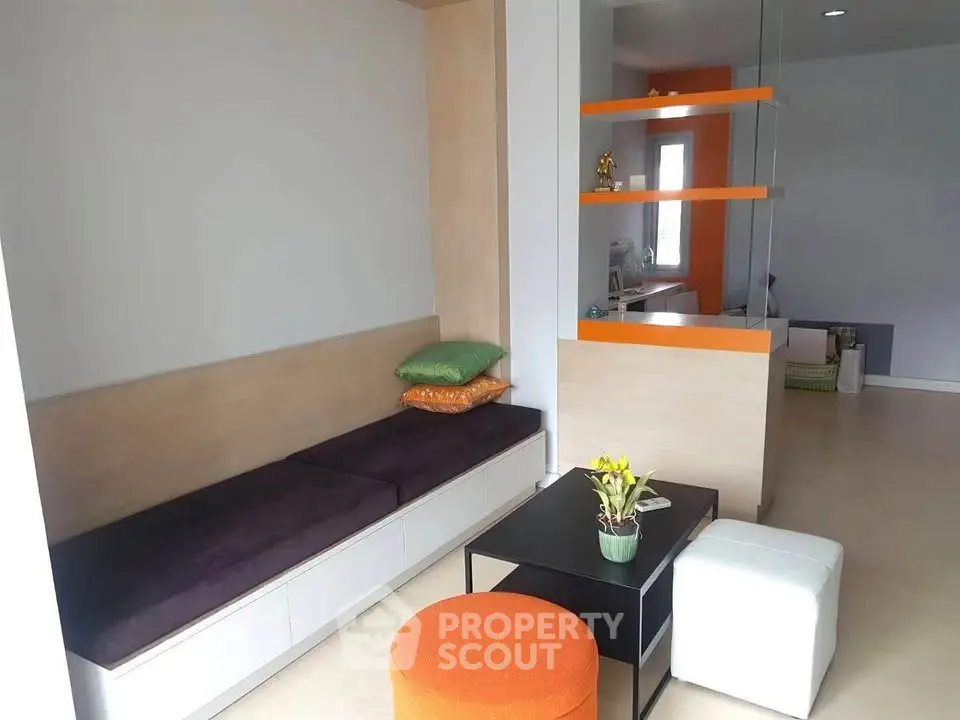 Modern living room with stylish seating and vibrant decor accents