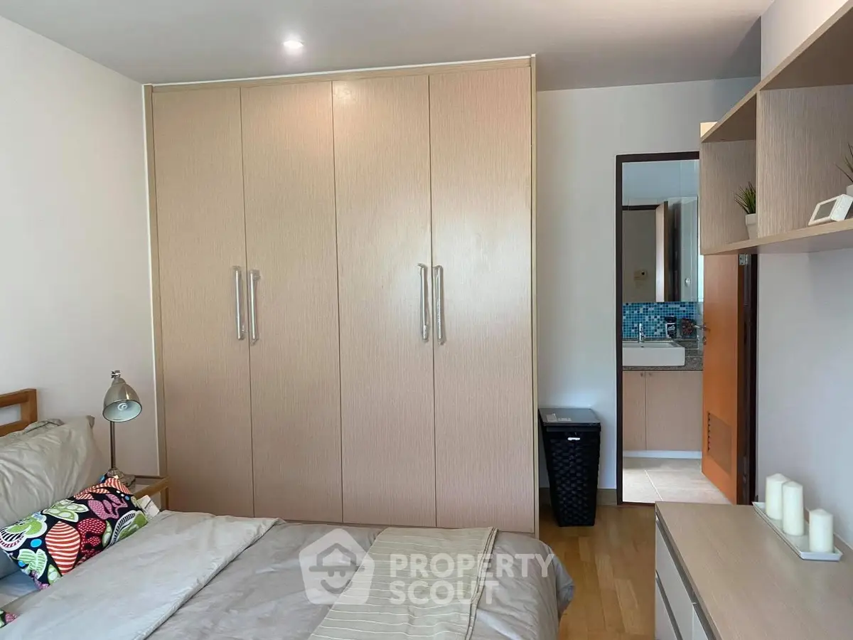 Cozy bedroom with modern wardrobe and stylish decor