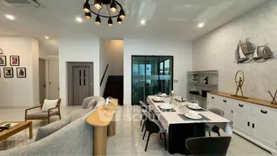 Modern open-plan living and dining area with stylish decor and elegant furniture.