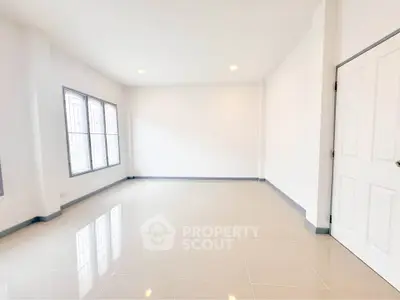 Spacious empty room with large windows and glossy tiled floor, perfect for customization.