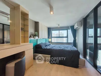 Modern bedroom with city view, featuring sleek design and ample natural light.