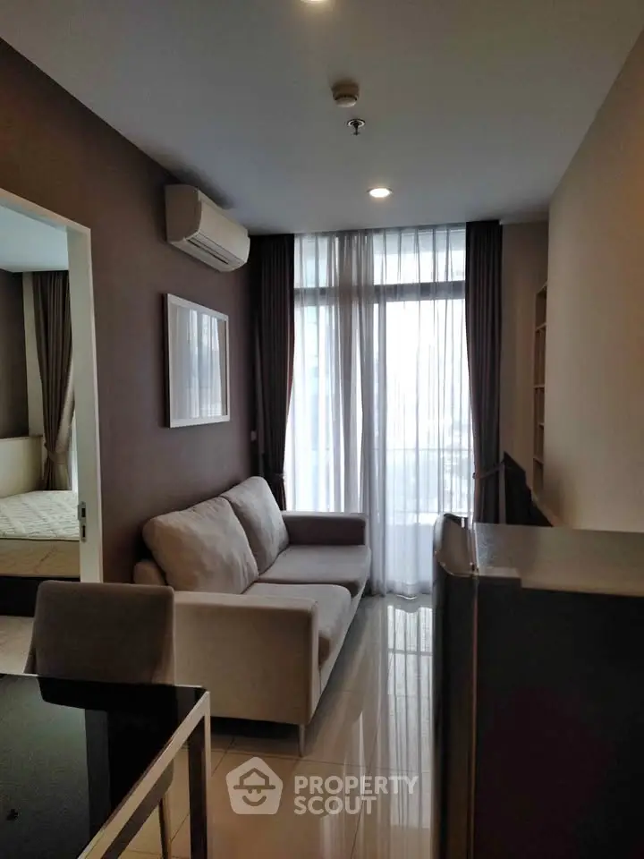 Modern living room with cozy sofa and large window in stylish apartment