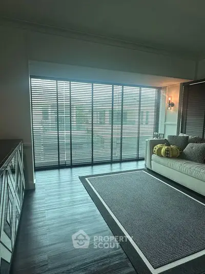 Elegant living room with floor-to-ceiling windows and stylish decor