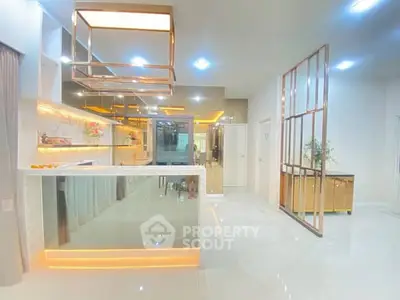 Modern kitchen with sleek open layout and reflective surfaces