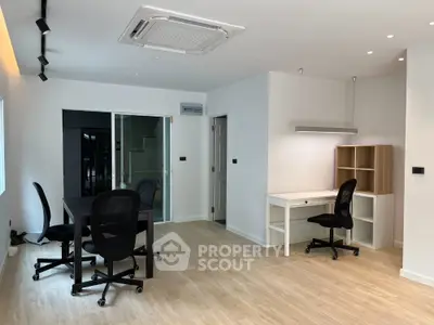 Modern study room with sleek furniture and wooden flooring