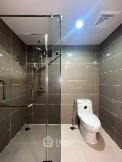 Modern bathroom with glass shower and sleek tile design