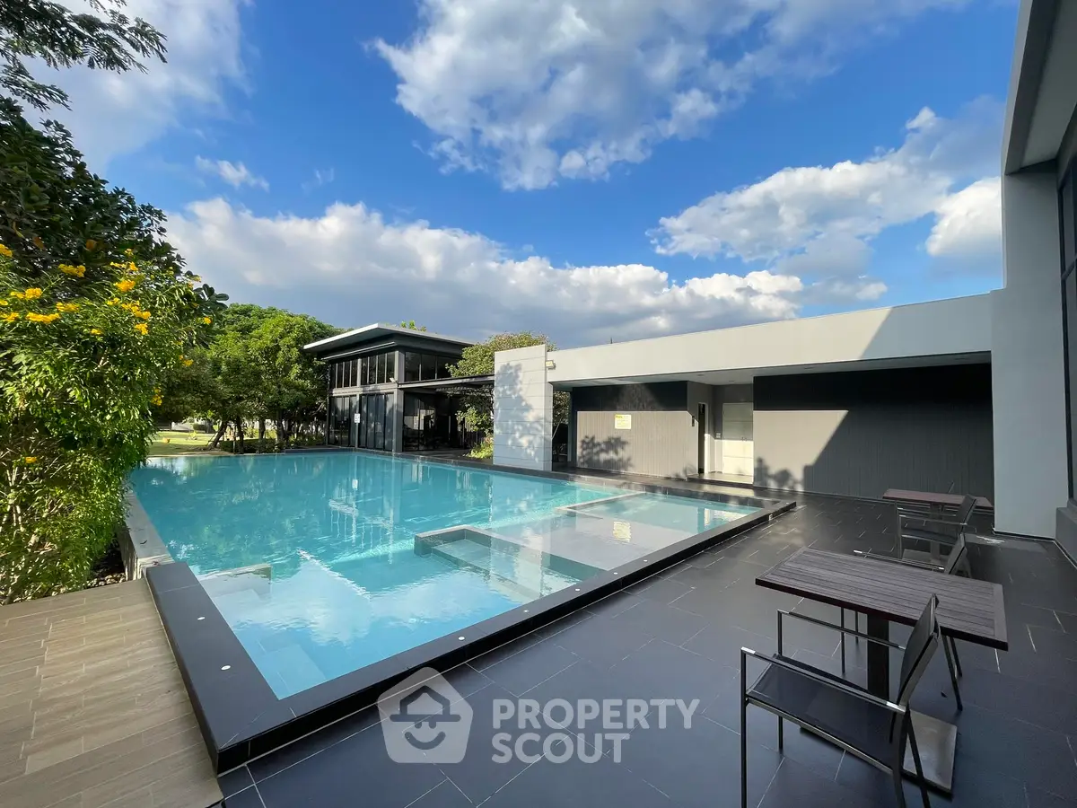 Luxurious modern pool area with sleek design and lush greenery
