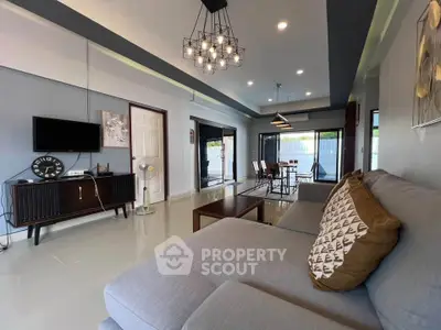 Spacious modern living room with stylish decor and large windows for natural light.