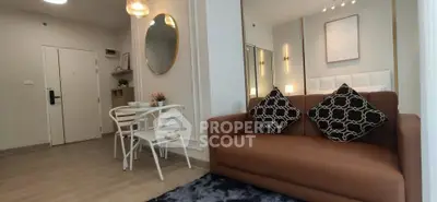 Modern living room with stylish decor and cozy seating in a contemporary apartment.