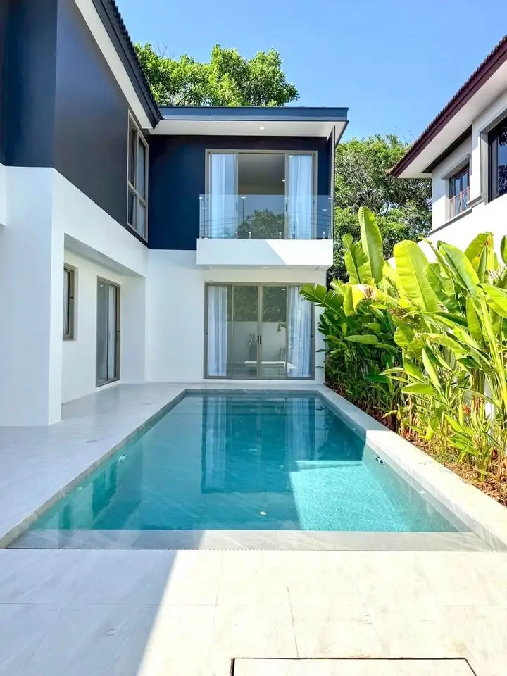 Luxurious modern villa with private pool and lush greenery, perfect for serene living.