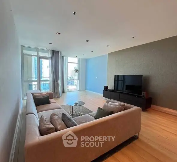 Spacious modern living room with large windows and city view