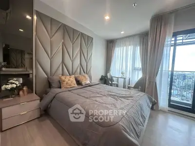 Luxurious bedroom with elegant decor and city view balcony in modern apartment.