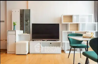 Modern living room with stylish furniture and elegant decor, featuring a sleek TV unit and dining area.