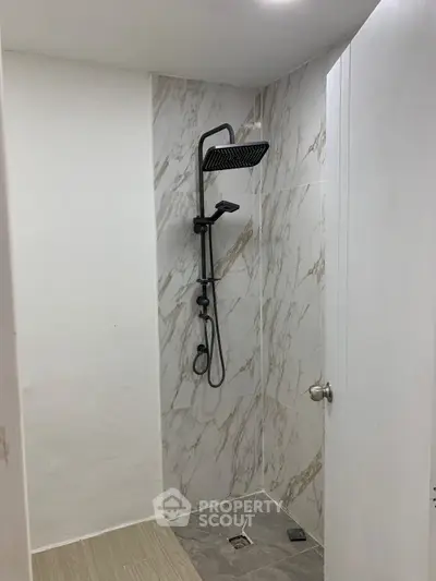 Modern bathroom with sleek shower design and marble wall tiles