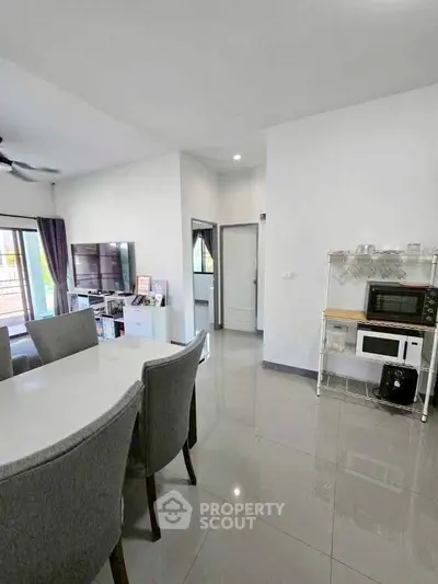 Modern living and dining area with sleek furniture and open layout