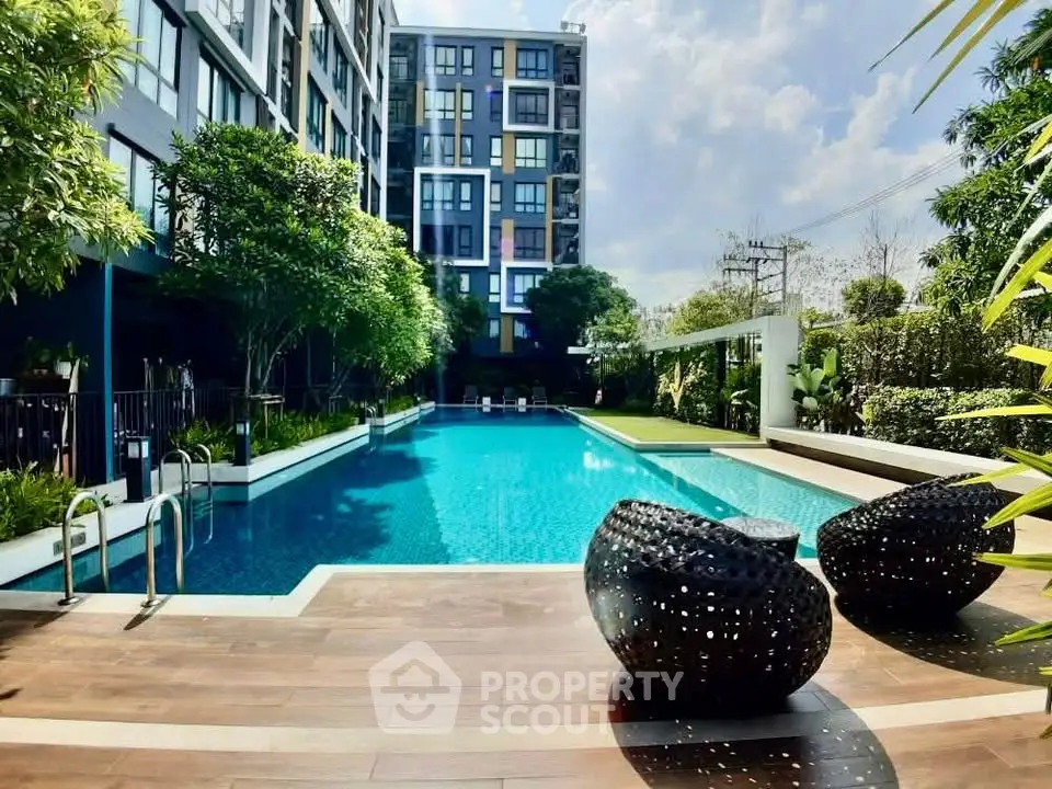 Luxurious apartment complex with stunning pool and lush greenery