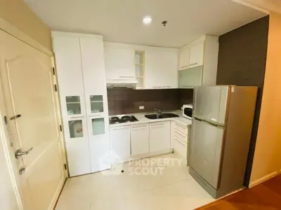 Modern kitchen with sleek white cabinets and stainless steel appliances