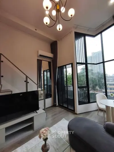 Modern living room with high ceiling and large windows offering city views